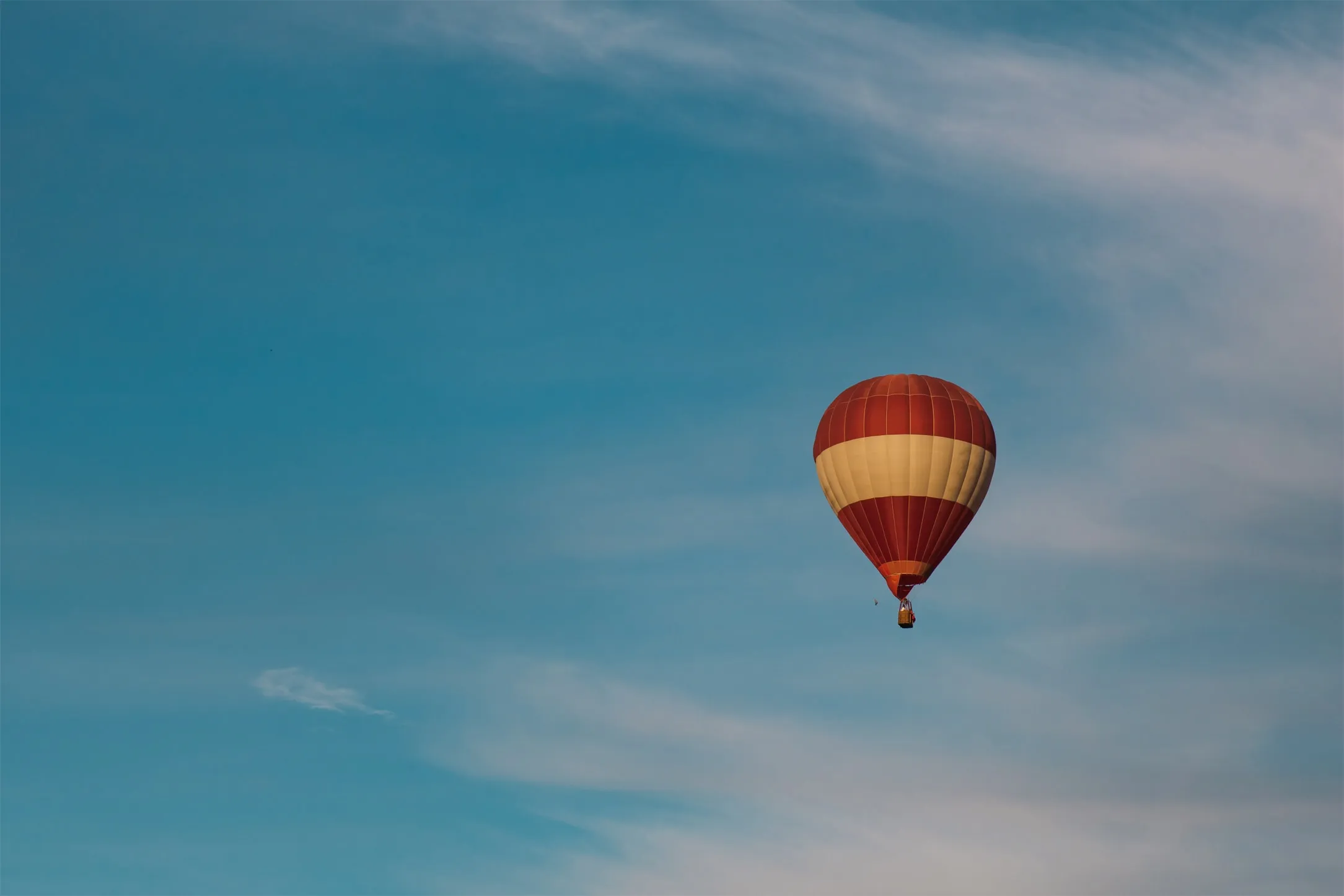 a picture of a hot air ballon soaring in the sky